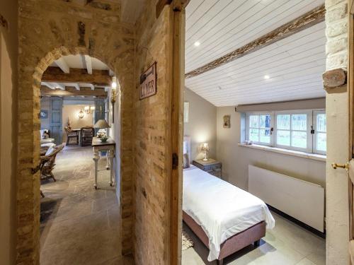 a bedroom with a bed and a table in a room at Holiday home with 3 bedrooms in Koksijde