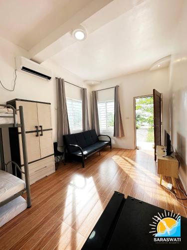 a living room with a couch and a bed at Saraswati Exclusive Resort in Esperanza