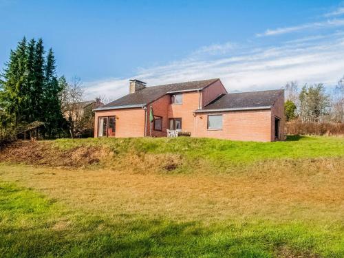 a house on top of a grassy hill at Quiet valley view retreat in Roy