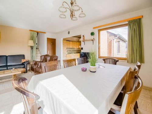 a dining room and living room with a table and chairs at Quiet valley view retreat in Roy