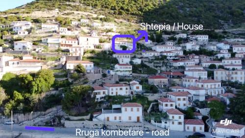 a town on a hill with the word shikara house at Ana & Angelo House Vuno Himare in Vuno