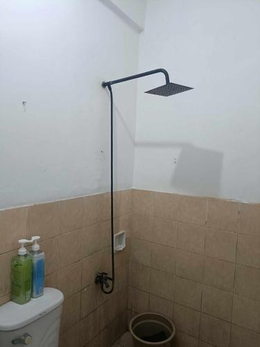a bathroom with a shower with a toilet and a sink at Chelsea's Haven - Entire House in Bacolod
