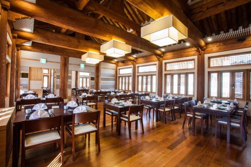 a dining room with tables and chairs and windows at Gyeongwonjae By Walkerhill in Incheon