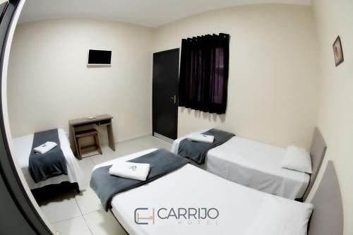 Katil atau katil-katil dalam bilik di Carrijo Hotel