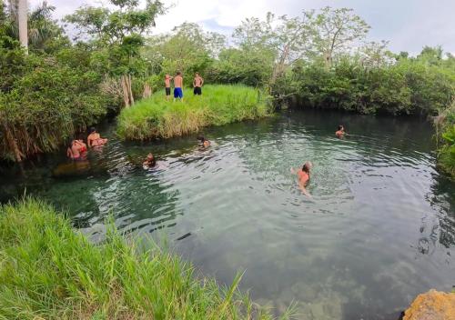a group of people swimming in a river at Casita Linda in Arecibo