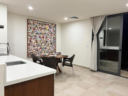 a kitchen and dining room with a table and chairs at Modern studio in a waterfront building in Cozumel