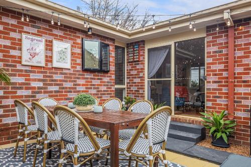 a wooden table and chairs on a patio at Gloria of Healesville in Healesville