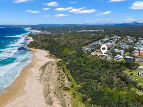 an aerial view of the beach and the ocean at Ocean Overlook - Rennies Beach holiday haven in Ulladulla
