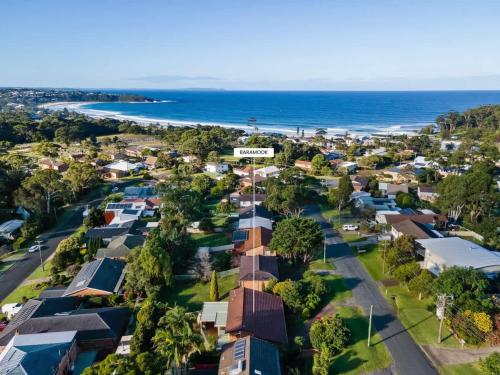 an aerial view of a town with houses and the ocean at Baramook - family home with golf & beach nearby in Mollymook