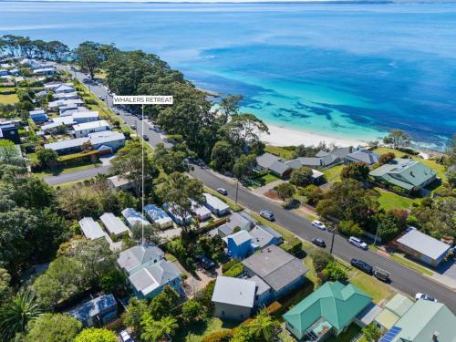 an aerial view of a suburb next to the ocean at Whalers Retreat - Hyams Beach 3BR cottage in Hyams Beach