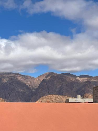 a view of a mountain range with a cloudy sky at maison de bonheur 2 in Tafraoute