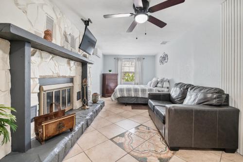 a living room with a couch and a fireplace at PRIVATE STUDIO near Busch Gardens & USF in Tampa