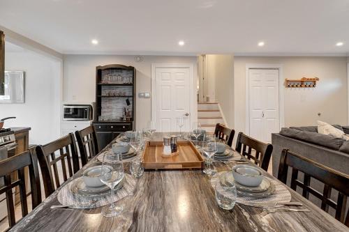 a dining room with a table with wine glasses on it at 3 Bedroom Modern Getaway with Hot Tub and Pet Friendly in Sudbury
