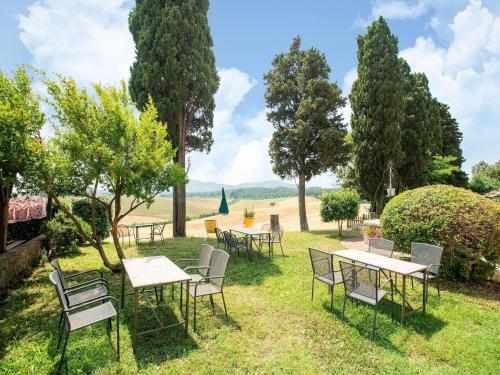 a group of tables and chairs in the grass at Apartment in Tuscany near Pisa and Beaches in Nugola