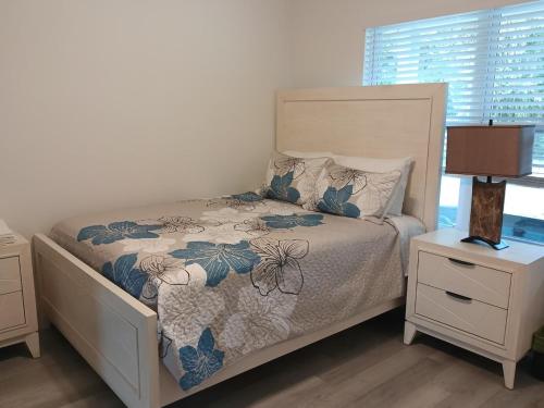 a bedroom with a bed and a night stand with a lamp at THE WHOLE HOUSE, QUIET COZY HOME 4 Bed 3 bath in Ocala