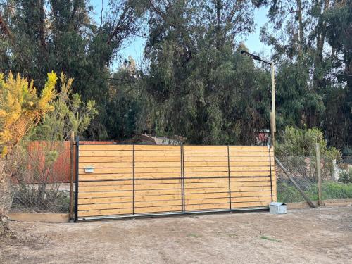 a wooden fence with a gate in a yard at Cabaña en Vallenar in Vallenar