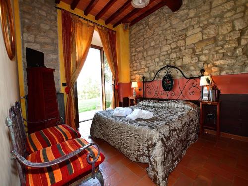 a bedroom with a bed and a stone wall at Apartment with pool, Rignano in San Cristoforo a Perticaia