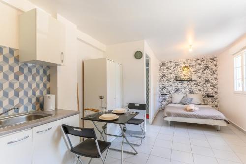 a kitchen and living room with a couch and a table at Le cocon de l'impasse à Tremblay en France in Tremblay En France