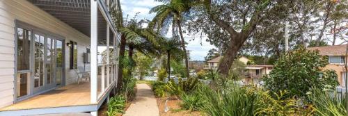 an empty porch of a house with a tree at Bowen View - pet-friendly home near Hyams Beach in Hyams Beach