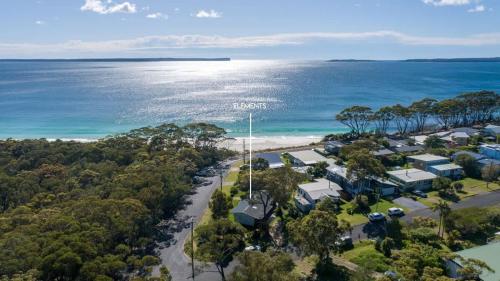 an aerial view of the beach and the ocean at Elements of Hyams - perfect Hyams Beach getaway in Hyams Beach
