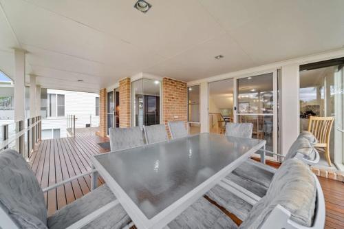 a dining room with a table and chairs at Footprints at Hyams Beach - 4BR home w. games room in Hyams Beach