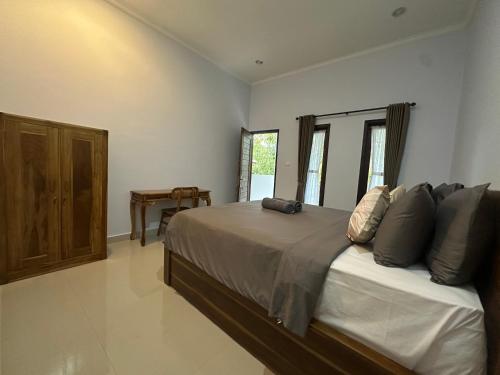 a bedroom with a large bed with pillows on it at Pristine penida in Nusa Penida