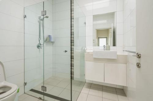 a bathroom with a shower and a sink and a toilet at Allure at Hyams Beach - seconds to white sands in Hyams Beach
