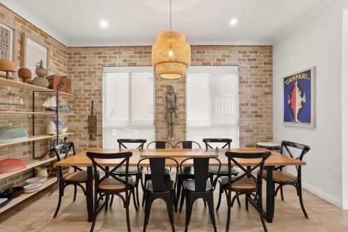 a dining room with a table and chairs at Sanctuary Lodge - 5BR waterfront country getaway in Sanctuary Point