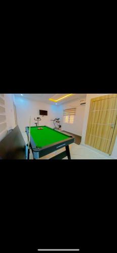 a green ping pong table in a room at NgoZiLiving in Lekki