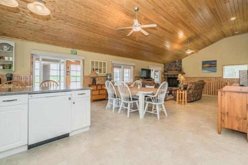 a kitchen and dining room with a table and chairs at Waterfront w sauna, hot tub and boat slip in Miller Lake