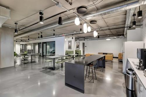 a large room with tables and chairs in it at Boulevard Stays Comfortable Downtown Highrise STU Pool Parking & Gym 10a in Phoenix