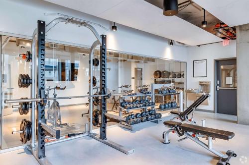 a gym with several treadmills and weights at Boulevard Stays Comfortable Downtown Highrise STU Pool Parking & Gym 10a in Phoenix