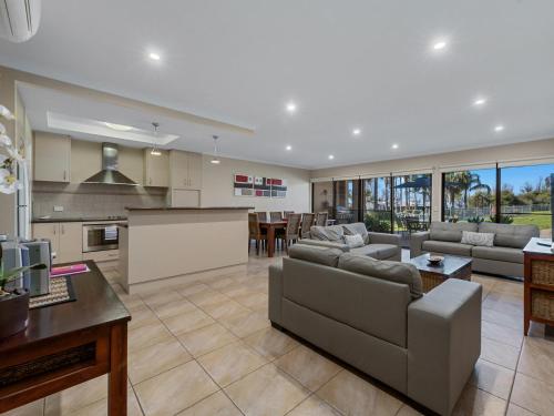 a large living room with a couch and a table at Elsinor Townhouse 3 in Mulwala