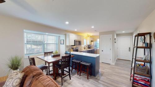 a kitchen and living room with a table and chairs at Beautiful Condo, Steps From Table Rock Lake & Sdc in Branson