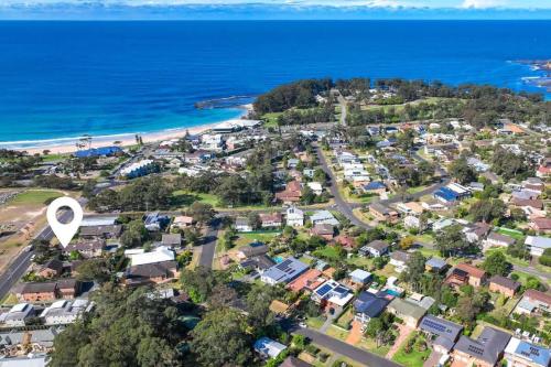 an aerial view of a suburb next to the ocean at Ocean Cove - cosy retreat steps from beach & cafes in Mollymook