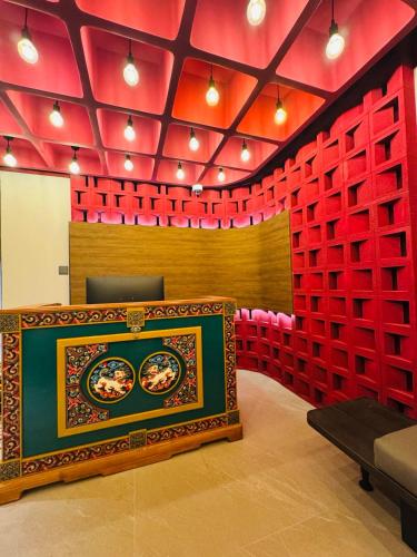 a room with red dividers and a stage at Monastery Hotel in Ulaanbaatar