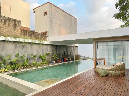 a swimming pool on the side of a building at New Spacious 4 bedrooms Family Villa with Skyline View in Panjadakan