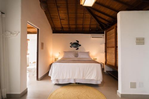 a bedroom with a bed with a soccer ball on the wall at Beijo do Vento Pousada in Arraial d'Ajuda