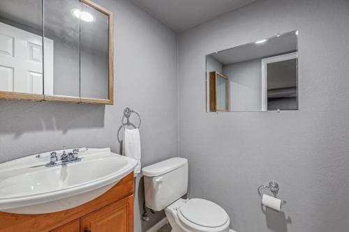 a bathroom with a sink and a toilet and a mirror at Modern Family Haven Fenced Yrd Grillfirepit in Westminster
