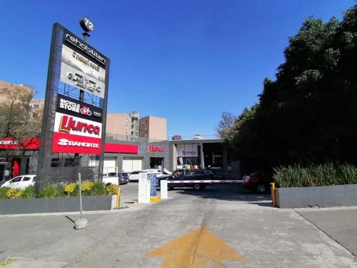 a gas station with a sign in a parking lot at Cute Quiet Studio, Smart Tv, Six Flags 1 Km in Mexico City