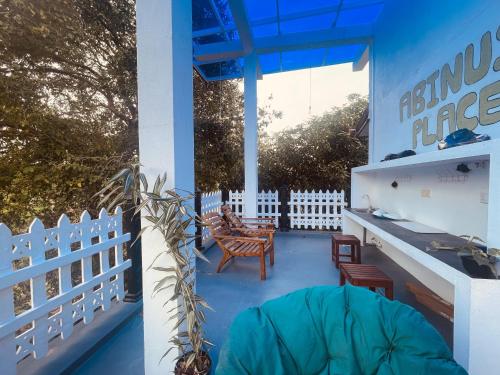 a patio with chairs and a table and a fence at Abinu"s Place in Dickwella