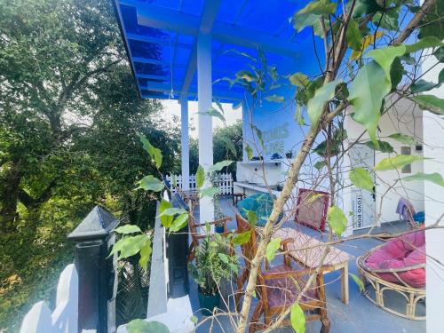 a view of a house with a table and chairs at Abinu"s Place in Dickwella