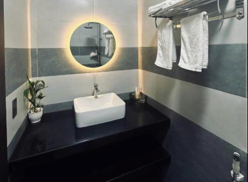 a bathroom with a sink and a mirror at Love Hotel in Hanoi