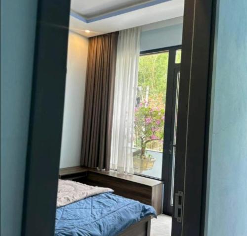 a reflection of a bedroom with a bed and a window at Love Hotel in Hanoi