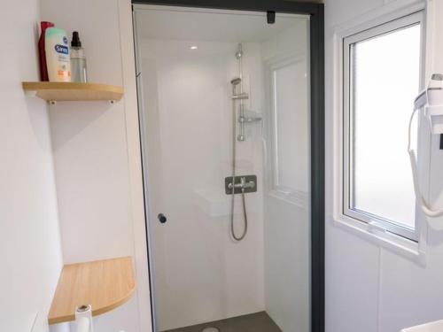 a shower with a glass door in a bathroom at Mobil Home 6 Pers avec Terrasse et Cuisine Équipée - API-1-52-561 in Granges-Aumontzey