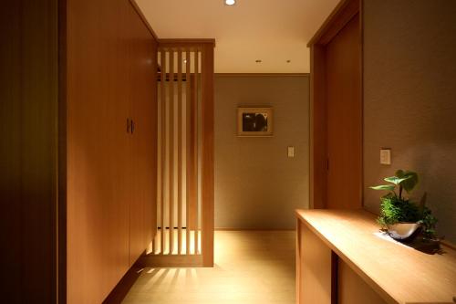 a hallway with a door with a plant on a counter at MAIHAMA VIEW HOTEL by HULIC Formerly Tokyo Bay Maihama Hotel in Urayasu