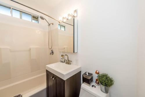 a bathroom with a sink and a tub and a toilet at Canyon View in San Diego