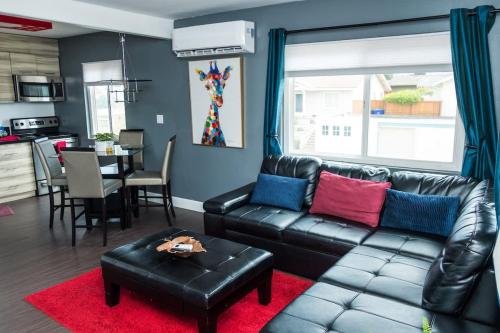 a living room with a leather couch and a table at Canyon View in San Diego
