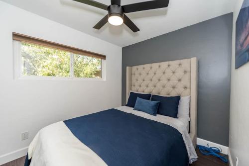 a bedroom with a bed and a ceiling fan at Canyon View in San Diego