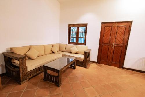 a living room with a couch and a coffee table at Ceylon Holiday Homes in Kandy